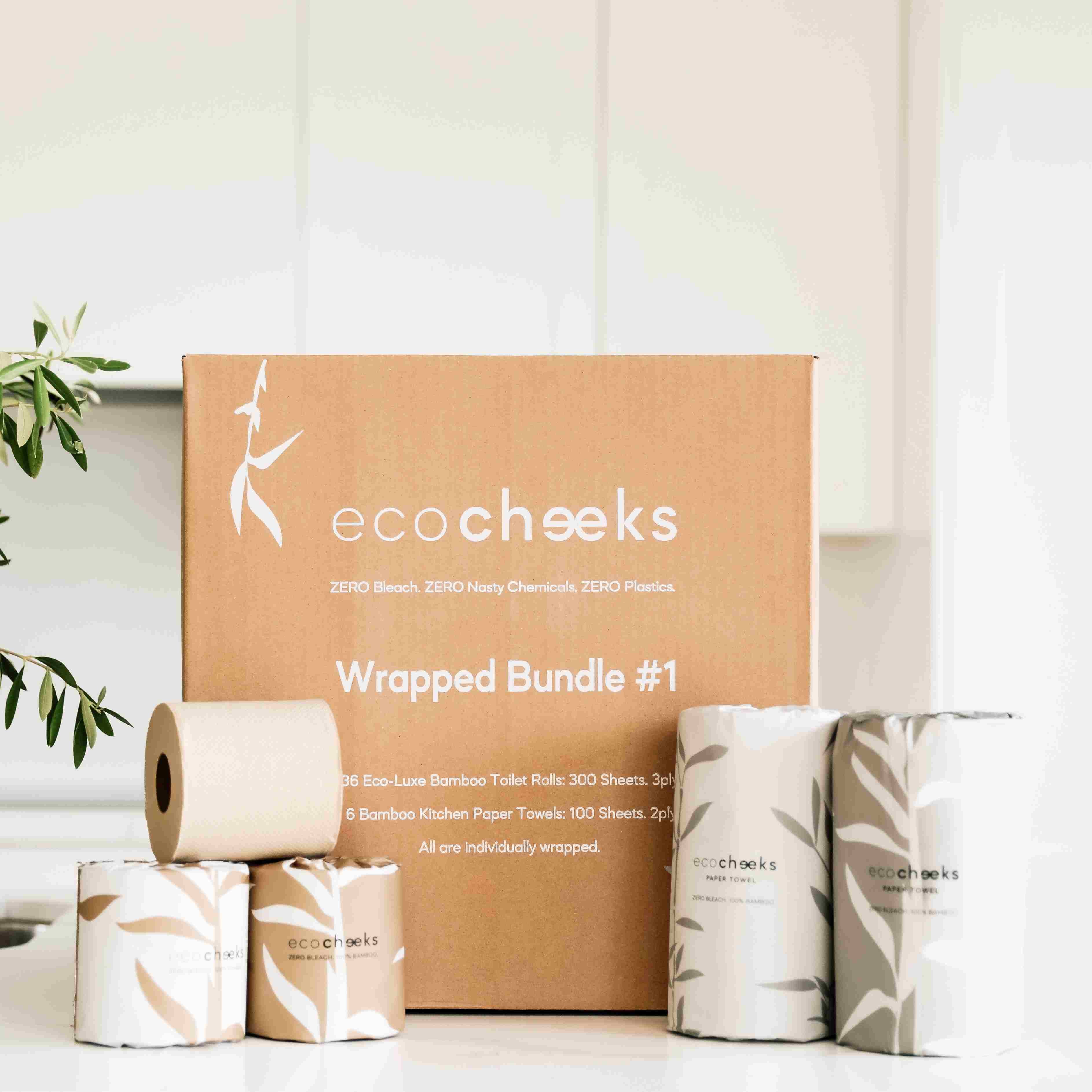 ecocheeks wrapped bundle with toilet paper and kitchen towels on a neutral background